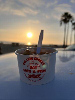 To-go cup of chowder at sunset at New Port Beach, Ca on May 6, 2022