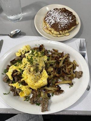 House made breakfast sausage hash and scrambled eggs with short stack of cornmeal pancakes.