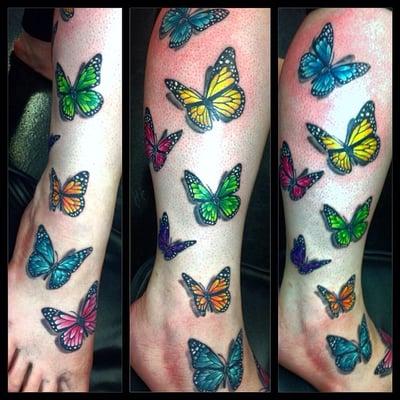 Colorful butterflies, these go all the way up her leg, by Eryka Jensen.