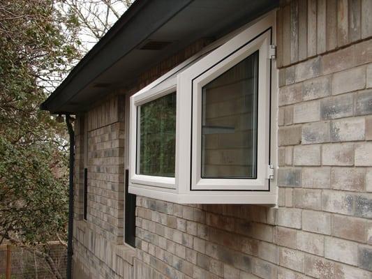 Simonton Garden window in vinyl frames with glass shelf. The two end panel crank out to allow for ventilation.