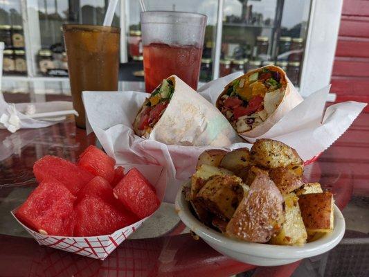 Grilled chicken wrap w/ mandarin orange, chopped veggies. Sided with watermelon and home fries.