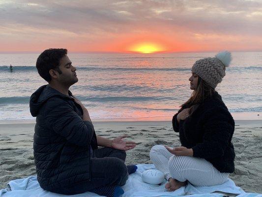 Chakra meditation at sunset on the beach