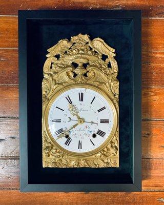 Antique clock framed in black velvet shadow box