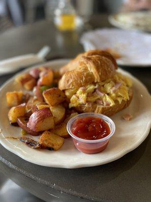 Breakfast croissant with potatoes