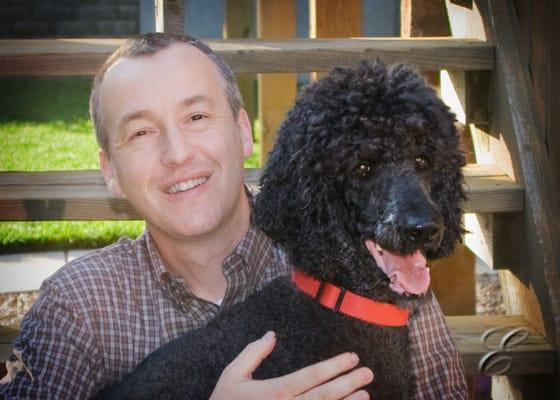 Dr. Gary Stamps and his family's Standard Poodle, Reagan. They adopted him from the Kansas Humane Society.