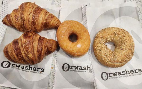 Croissants, glazed donut and sesame bagel