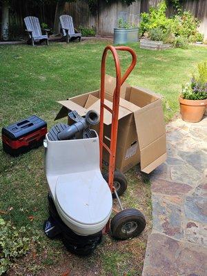 Rudy hauled away the old toilet and the new toilet's box.