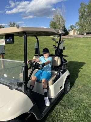 Liam using a golf cart in the South Par three.