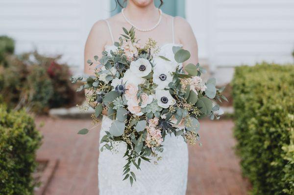 Cascading bridal bouquet with anemones, succulents and more.