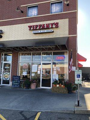 Store front with outside seating to the right.