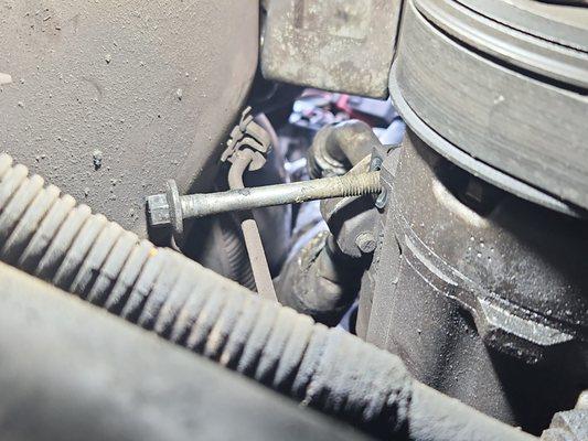 A/C Compressor Bolt 
 that was never screwed back down. belt is to lose 
 to turn. never again