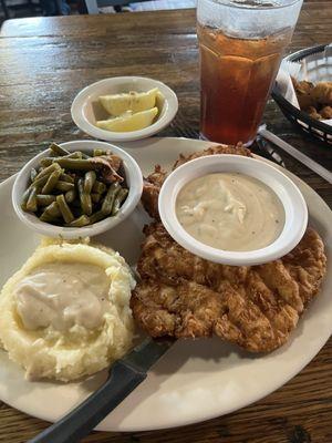 Chicken fried chicken with gravy, real mashed potatoes & gravy with green beans.