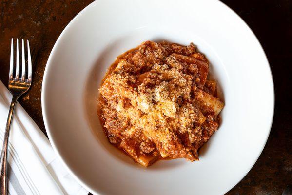 Paccheri Calabrese - Artisanal crafted Paccheri noodles, house-made sausage, spicy Calabrian 'nduja, burrata, tomato