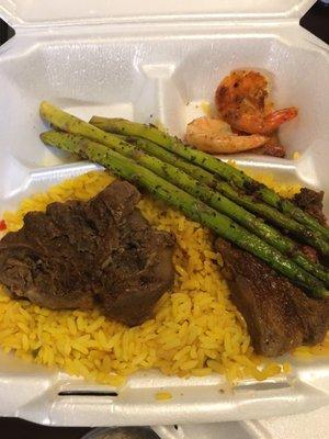 Lamb chops with shrimp, asparagus and yellow rice