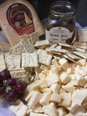 Unique selection of cheeses, crackers and tapanades.