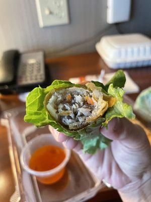 Inside the egg roll - rolled in lettuce with a mint leaf and dipped into fish sauce.