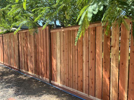 Redwood rail top peeka boo fence