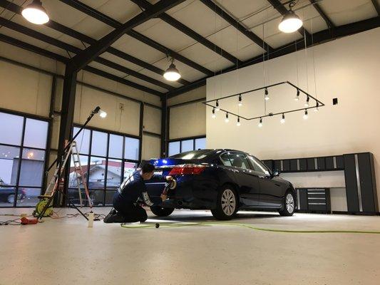 A Mr. Detail Tech. enhancing the gloss of this Honda Accord.