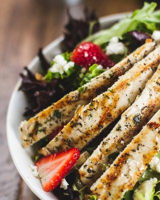 Fragole Salad: mixed greens, goat cheese, caramelized walnuts, strawberries, grilled chicken, apple-cider dressing.