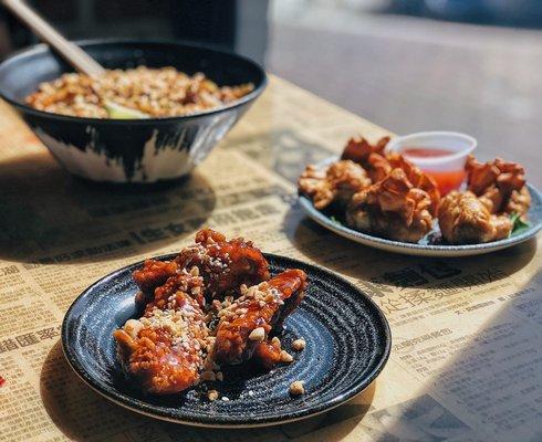 Korean Twice Fried Wings Plate/ 6 Golden Wontons Plate Pad Thai (foreground)