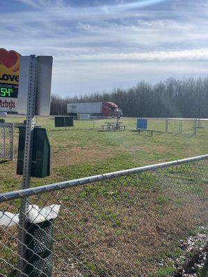 Small enclosed dog area. Trash cans. Seating. Bring your own poop bags.