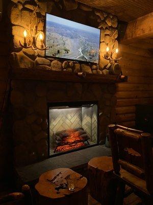 Cozy fireplace with TV above