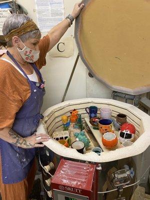 Pottery is stacked in layers for the kiln