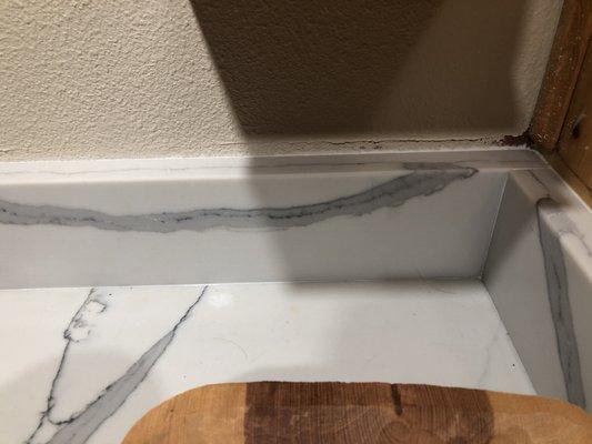 They were suppose to make backsplash the same height as old backsplash to cover marks. Now I have to have painters come back in to paint.