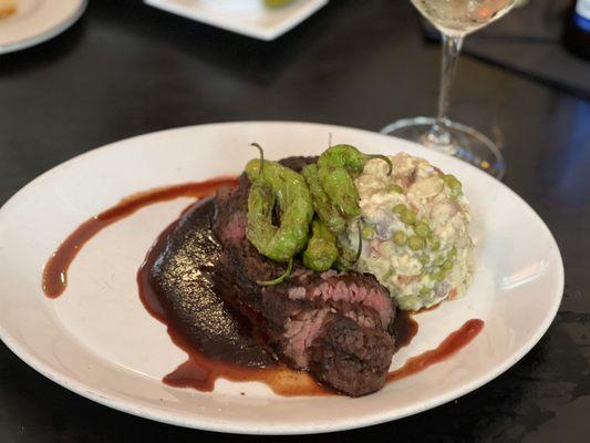 Cajun Rubbed Hangar Steak over Barbecue Demi Glacé, topped with Fried Shishito Peppers, served with Warm Potato Salad with Peas & Carrots