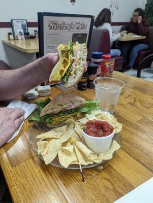 Chicken curry sandwich with chips and salsa