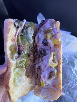 Philly cheese steak with jalapeños, pickles, red onions, olives, and banana peppers.