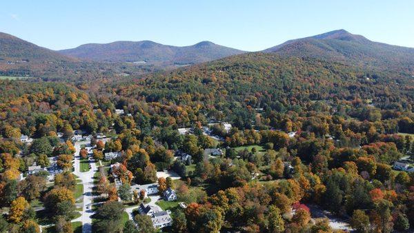 Beautiful landscape drone photo of Dorset with beautiful mountains in the background and changing colored trees