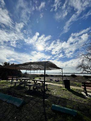 Outdoor seating and viewing area next to the water.