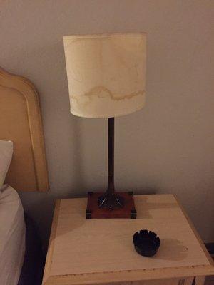 Stained lamp shade on the night stand.