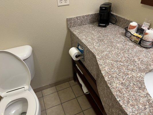 In-bathroom coffee station next to toilet.