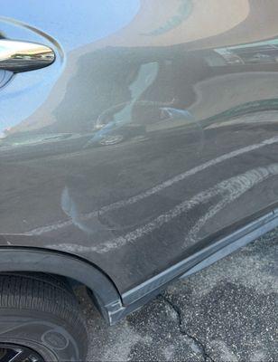 Scuff marks left on the back passenger door.