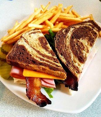 Club~Hickory smoked bacon, sliced Black Forest Ham, sliced roasted turkey, cheddar cheese, Swiss cheese, lettuce, tomato on marble rye!