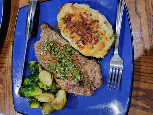 Twice baked, fully loaded  potato, chimichurri steak, and brussel sprouts