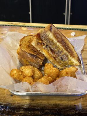 Grilled cheese cheeseburger and bacon with a side of tots.