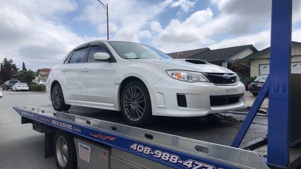 Car being towed to the shop.