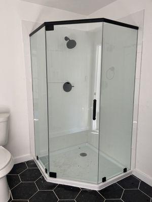 Shower door with matte black header