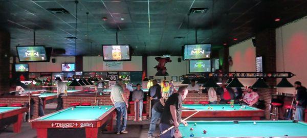 Big pool hall with many tables.