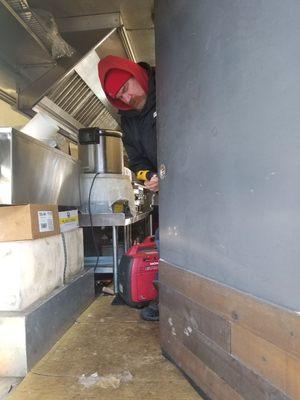 Replacing a door lock on a food truck.