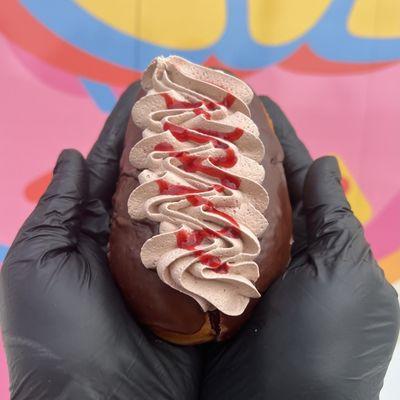 The raspberry Dream! Our raspberry filled donut, topped with chocolate glaze, chocolate cream, and raspberry drizzle!