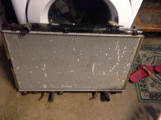 My radiator with the cracked plastic with the water leaked out and the missing brass pieces from the side