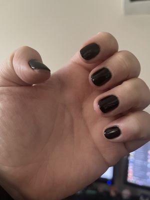 Faint shadows of nail polish that had smudged which the nail tech noticed but did not remove (just half attempted to scrape off)