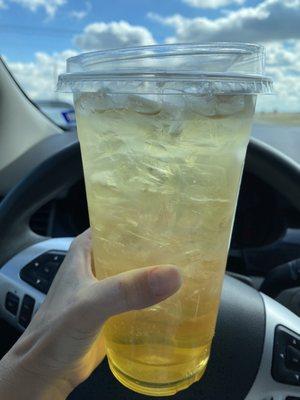 Large iced green tea with passion fruit syrup