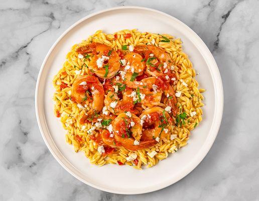 Jumbo shrimp sauteed in a traditional Greek sauce made with aromatic garlic, tangy Feta cheese and Roma tomatoes, over Kritharaki pasta