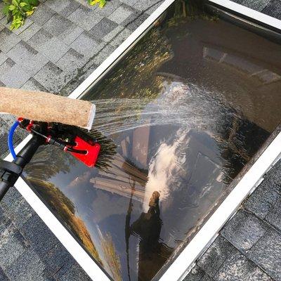 Water fed pole on skylight