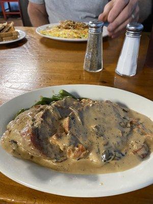 Roast pork special with green beans & mashed potatoes. My husband had the Okie omelet with hash browns & toast